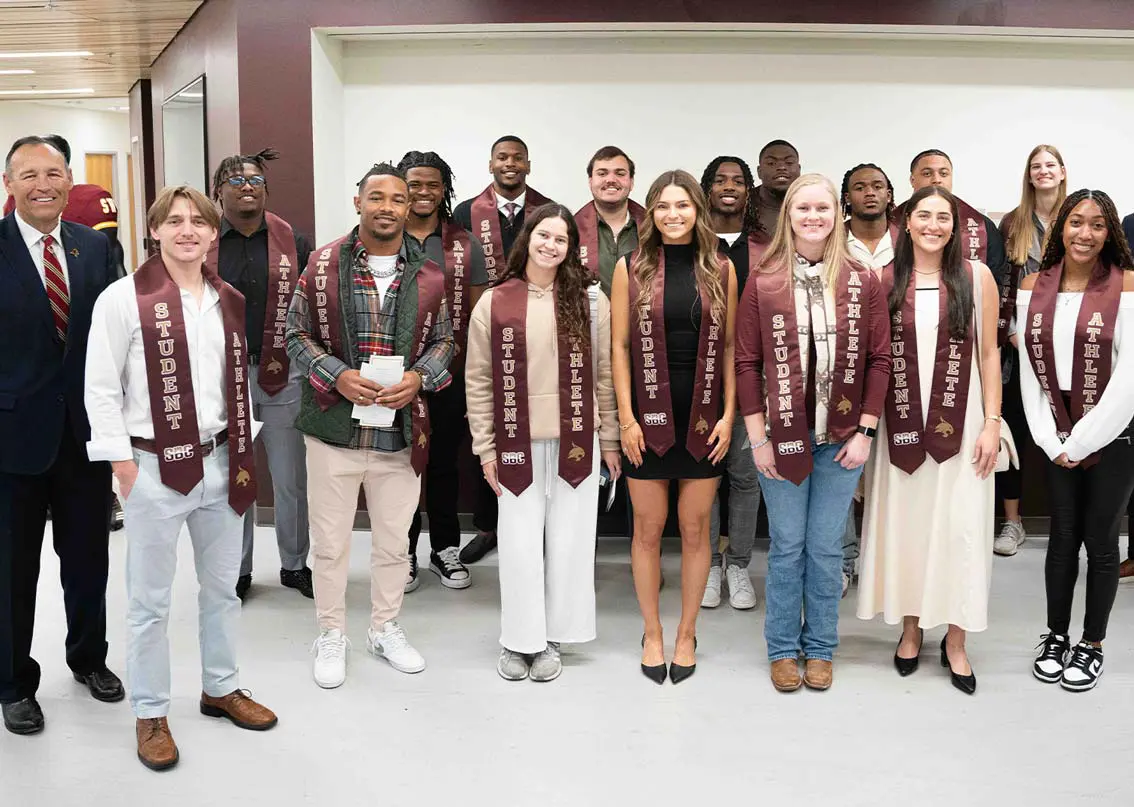 Group of people wearing student athlete scarves